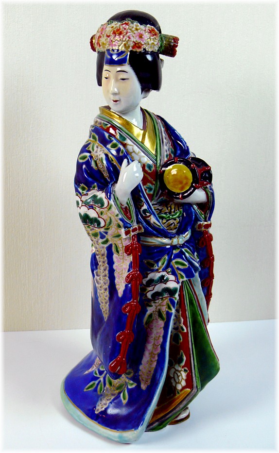 Japanese antique porcelain figurine of a woman with small drum in her hand, 1850's