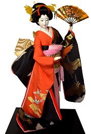japanese traditional doll of a dancing young lady with folding fan