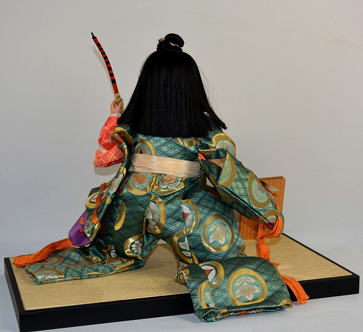 Japanese doll of a young samurai with arrows and bow