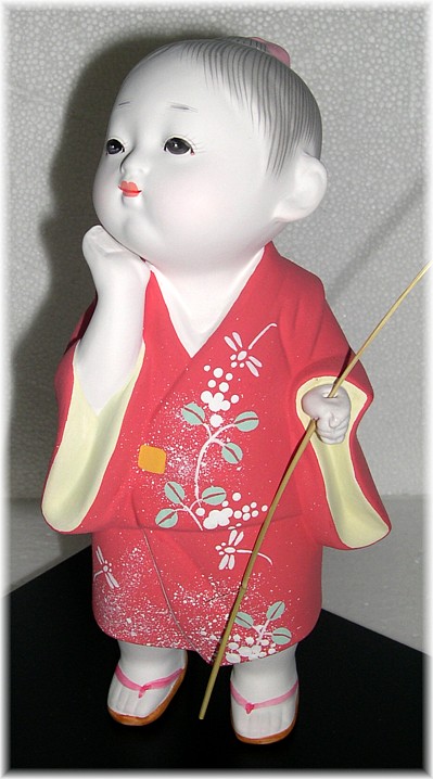 Japanese Hakata clay doll of a Boy with twig