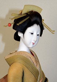 japanese antique doll of a geisha with umbrella