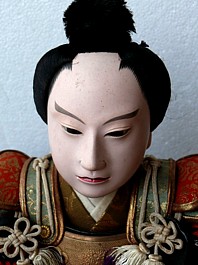 japaneseantique doll of a samurai warrior lord, sitting with tessen battle fan in his hand