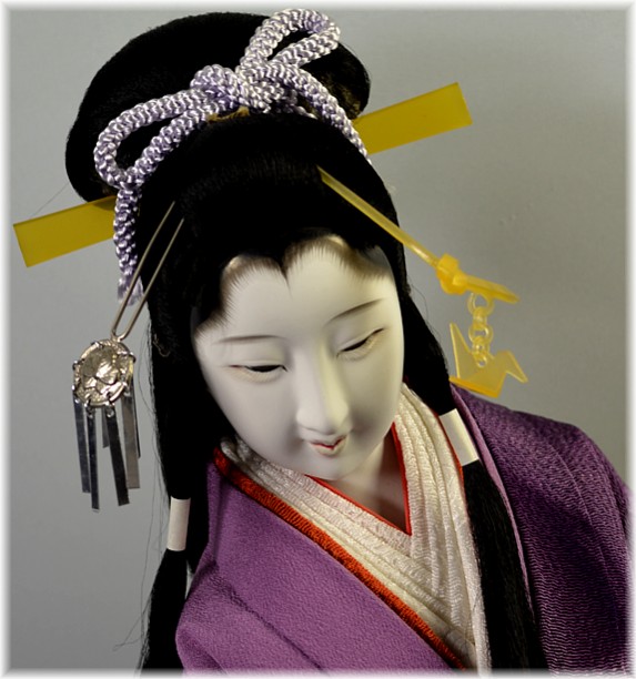 japanese traditional doll of a long hair beauty dancing with folding fan