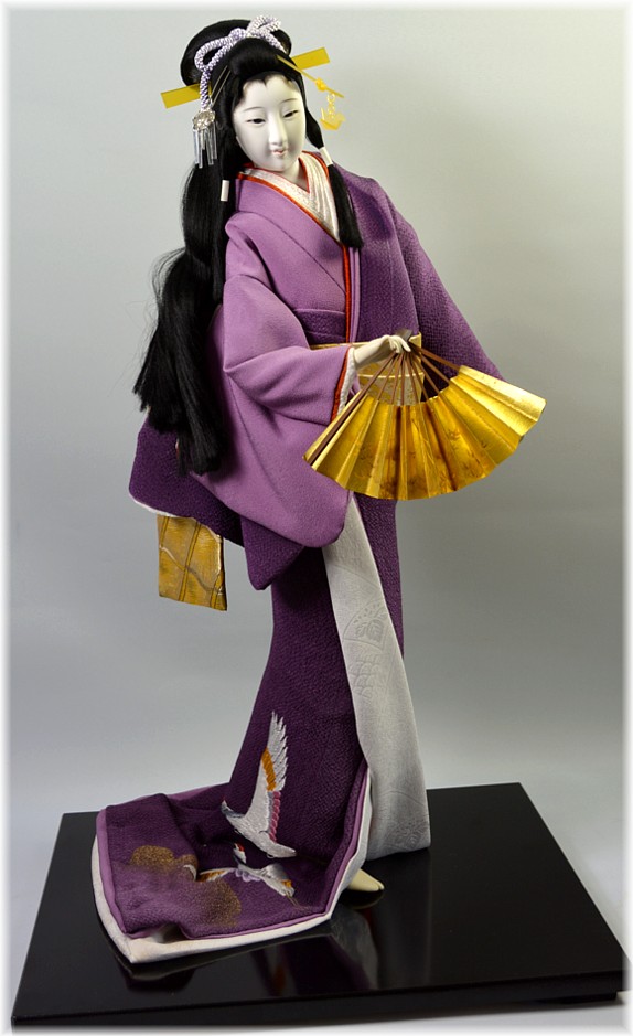 japanese traditional doll of a dancing beauty with folding fan