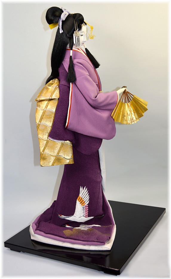 japanese traditional doll of a dancing beauty with folding fan