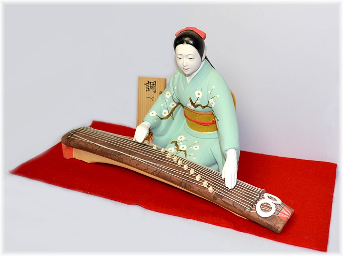 a musician fingering koto, Japanese Hakata figurine