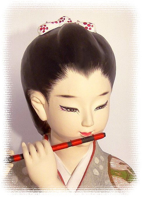 japanese hakata doll of a girl playing the flute, 1970's