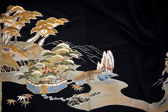 japanese antique kimono: detail of embroidering and painting on black silk background